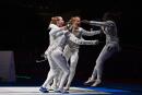 TOPSHOT - France's Ysaora Thibus (2nd - L) celebrates with her teammates after winning against Italy's Arianna Errigo compete against in the women's foil team semifinal bout during the Tokyo 2020 Olympic Games at the Makuhari Messe Hall in Chiba City, Chiba Prefecture, Japan, on July 29, 2021. (Photo by Fabrice COFFRINI / AFP) 