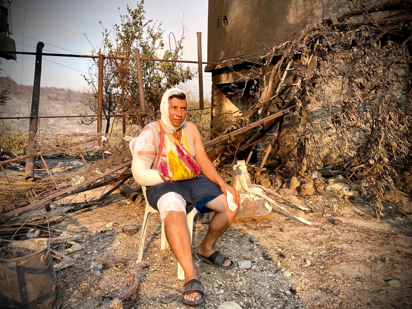 A resident of the southern Turkish city of Manavgat, amid the ruins of her burnt-out house.