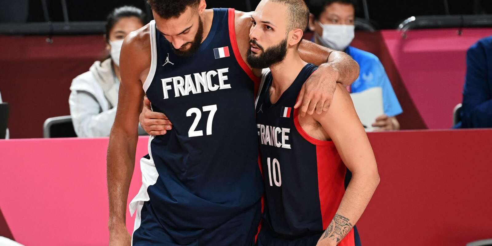 France's Rudy Gobert (L) reacts next to teammate Evan Fournier after France's defeat in the men's final basketball match between France and USA during the Tokyo 2020 Olympic Games at the Saitama Super Arena in Saitama on August 7, 2021. (Photo by Mohd RASFAN / AFP)