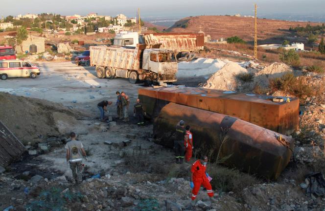 Lebanese army soldiers and rescuers respond to the site of a fuel tanker explosion in Akkar, northern Lebanon, August 15, 2021.