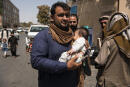Agence France Presse Photographer Noorullah Shirzada carries his infant child inside Kabul's green zone in order to be transported to the international airport for evacuation flights. Yesterday, an agreement was reached by the Taliban leadership and the Afghan Government which saw President Ashraf Ghani step down in a transfer of power that saw barely any blood shed in the takeover of the capital. The takeover of the country transpired rapidly after U.S. and international forces began their final military from Afghanistan on May 1 this year. Since then, the Taliban swarmed across the countryside and then, ultimately, in early August, began overrunning provincial capitals, taking all 34 in a period of ten days, including Kabul, which they had surrounded by early this morning. The Taliban leadership instructed their fighters not to enter the city, though some appeared not to have received that order, parading through the streets on motorcycles and in Toyota Corollas. Government security forces were also asked to maintain security in the capital until further arrangements were made. By the afternoon most members of the government's security forces had shed their uniforms and most had left their posts, leaving somewhat of a power vacuum.