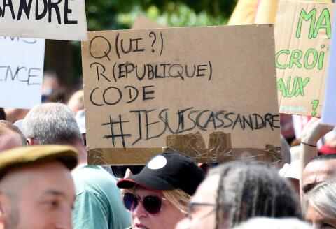 Demonstrators holds up placards that read, '#I am Cassandre', refering to Cassandre Fristot who was arrested for her antisemitic sign during the demonstration on August 7, during a national day of protest against the compulsory Covid-19 vaccination for certain workers and the compulsory use of the health pass called for by the French government in Metz on August 14, 2021. (Photo by JEAN-CHRISTOPHE VERHAEGEN / AFP)
