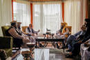 In this handout photograph released by the Taliban, former Afghan President Hamid Karzai, center left, senior Haqqani group leader Anas Haqqani, center right, Abdullah Abdullah, second right, head of Afghanistan's National Reconciliation Council and former government negotiator with the Taliban, and others in the Taliban delegation, meet in Kabul, Afghanistan, Wednesday, Aug. 18, 2021. The meeting comes after the Taliban's lightning offensive saw the militants seize the capital, Kabul. (Taliban via AP)