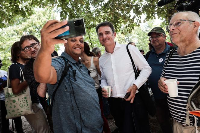 The candidate for the primary ecologist Eric Piolle poses with activists on the second day of the Ecologist Summer Days, in Poitiers, August 20, 2021.