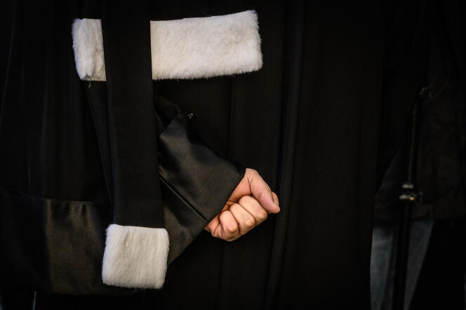 A lawyer clenches his fist during a demonstration against the pension reform, on January 6, 2020, in Lyon.