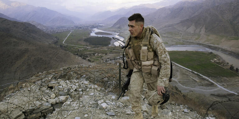 ASADABAD, AFGHANISTAN - JANUARY 31: A U.S. Marine, Corporal Gravenese from Harrison, New York, patrols in Asadabad, Afghanistan, 10 kms from the Pakistani border, January 31, 2004. Asadabad, in Kunar Province, is part of the ethnic Pathan tribal belt in eastern and southern Afghanistan. During the Soviet occupation, Kunar had many Arab Mujahideen living in the surrounding Hindu Kush mountains. Osama bin Laden is rumored to be hiding in Kunar Province. The Kunar River flows in the background. (Photo by Robert Nickelsberg/Getty Images)
