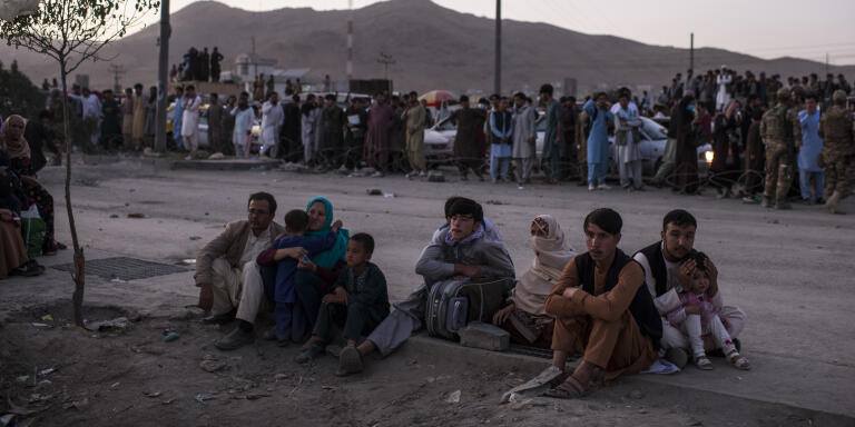 Hundreds of people wait outside the northwestern gate to Hamid Karzai International Airport, waiting and hoping to gain entry. They are among the tens of thousands who have attempted to gain entry to the airport, and to then board evacuation flights since the Taliban took control of the Afghan capital on August 15. Even those with valid travel documents, however, have found it incredibly difficult to navigate the treacherous paths and gateway to the airport, where Taliban fighters, U.S. Marines, British soldiers and Afghan paramilitary units control access. The northwestern gate, today, was controlled by the notorious CIA-backed paramilitary unit known as 01. Late today, Zabihullah Mujahid, the Taliban spokesman, declared that Afghans wanting to flee the country would be forbidden from accessing the airport.