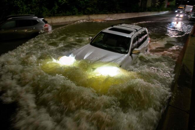 A motorist drives a car on a flooded expressway in Brooklyn, New York, following Storm Ida in the United States on September 2, 2021.