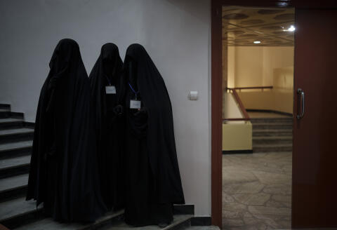 Women stand inside an auditorium at Kabul University's education center during a demonstration in support of the Taliban government in Kabul, Afghanistan, Saturday, Sept. 11, 2021. (AP Photo/Felipe Dana)