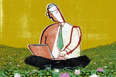 Businessman sitting in clover using laptop
