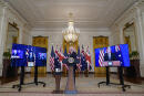 President Joe Biden, listens as he is joined virtually by Australian Prime Minister Scott Morrison, left, and British Prime Minister Boris Johnson, speaks about a national security initiative in the East Room of the White House in Washington, Wednesday, Sept. 15, 2021. (AP Photo/Andrew Harnik)