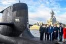 (FILES) A file photo taken on May 2, 2018 shows French President Emmanuel Macron (2/L) and Australian Prime Minister Malcolm Turnbull (C) standing on the deck of HMAS Waller, a Collins-class submarine operated by the Royal Australian Navy, at Garden Island in Sydney. Australia is expected to scrapped a 66 billion USD deal for France to build submarines, replacing it with nuclear-powered subs using US and British technology. - (Photo by BRENDAN ESPOSITO / POOL / AFP)

