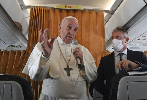 Pope Francis speaks with journalists on board an Alitalia aircraft enroute from Bratislava back to Rome, Wednesday, Sept. 15, 2021 after a four-day pilgrimage to Hungary and Slovakia. (Tiziana Fabi, Pool via AP)