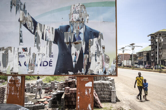 A torn poster featuring former Guinean President Alpha Condé on September 16, 2021 in Conakry.