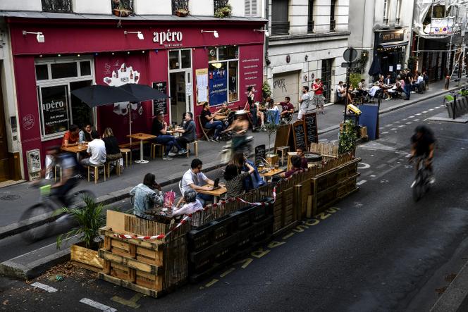 People have a drink on the terrace of a bar, quai de Jemmapes, in the 10th arrondissement of Paris, July 23, 2020.