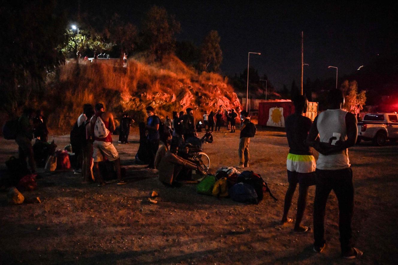 Unaccompanied minors gather outside Vathy camp, on the Greek island of Samos, which was partially destroyed by fire, Sunday, September 19, 2021.