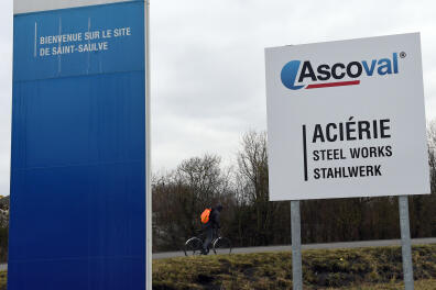 An employee arrives on a bicycle to the Ascoval steel works factory in Saint-Saulve, northern France, on January 29, 2018. - Production has been stopped at the Ascoval steel works factory in Saint Saulve, following the decision of the court on January 29 to award the takeover of Ascometal to the Swiss company Schmolz &amp; Bickenbach, without the Ascoval steel plant, contrary to promises made by the French president. (Photo by FRANCOIS LO PRESTI / AFP)
