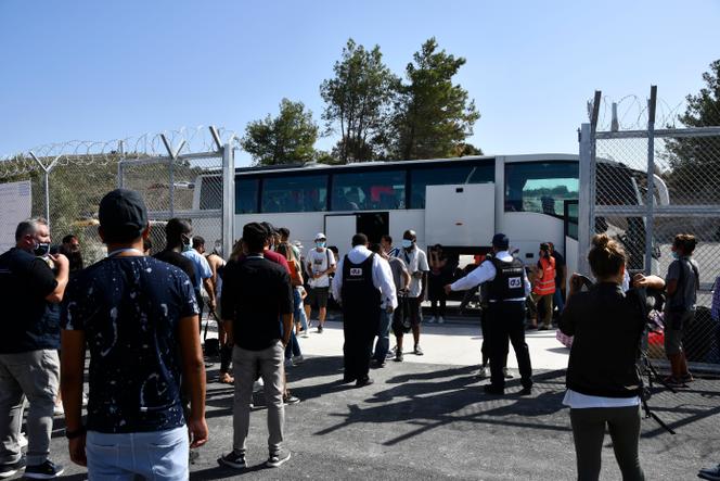 Security personnel screen migrants as they arrive at the new, closed guarded facility in the village of Zervou, on the eastern Aegean island of Samos, Greece, on September 20, 2021.