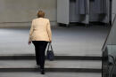 File - In this Tuesday, Sept. 7, 2021 file photo, German Chancellor Angela Merkel leaves the plenary hall after a debate about the situation in Germany ahead of the upcoming national election in Berlin, Germany. Angela Merkel, Germany's first female chancellor, has been praised by many for her pragmatic leadership in a turbulent world and celebrated by some as a feminist icon but she wouldn't seek reelection in the country's Sept. 26 general election. (AP Photo/Markus Schreiber, File)