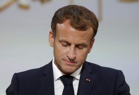 French President Emmanuel Macron pauses as he delivers a speech during a meeting in memory of the Algerians who fought alongside French colonial forces in Algeria's war, known as Harkis, at the Elysee Palace in Paris, Monday, Sept. 20, 2021. Macron's speech is the latest step in his efforts to reconcile France with its dark colonial past, especially in Algeria. (Gonzalo Fuentes/Pool Photo via AP)