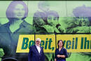 Annalena Baerbock, co-leader of Germany's Greens and her party's candidate for Chancellor, and politician of the Greens and former German Foreign Minister Joschka Fischer pose in front of Baerbock's tour bus on August 16, 2021 as they campaign in Frankfurt an der Oder, eastern Germany, ahead of the upcoming September 26 elections. (Photo by John MACDOUGALL / AFP)