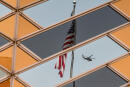 US national flag is reflected on the windows of the US embassy building in Kabul on July 30, 2021. (Photo by SAJJAD HUSSAIN / AFP)