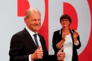 FILE PHOTO: Social Democratic Party (SPD) leader and top candidate for chancellor Olaf Scholz and party co-leader Saskia Esken react after first exit polls for the general elections in Berlin, Germany, September 26, 2021. REUTERS/Wolfgang Rattay/File Photo