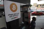 A sign invites customers at a San Salvador gas station to pay with bitcoins on September 30, 2021.