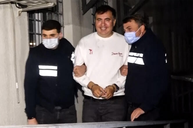 Screenshot of a video showing former Georgian President Mikheil Saakashvili being escorted by a police officer in Tbilisi on October 1, 2021.