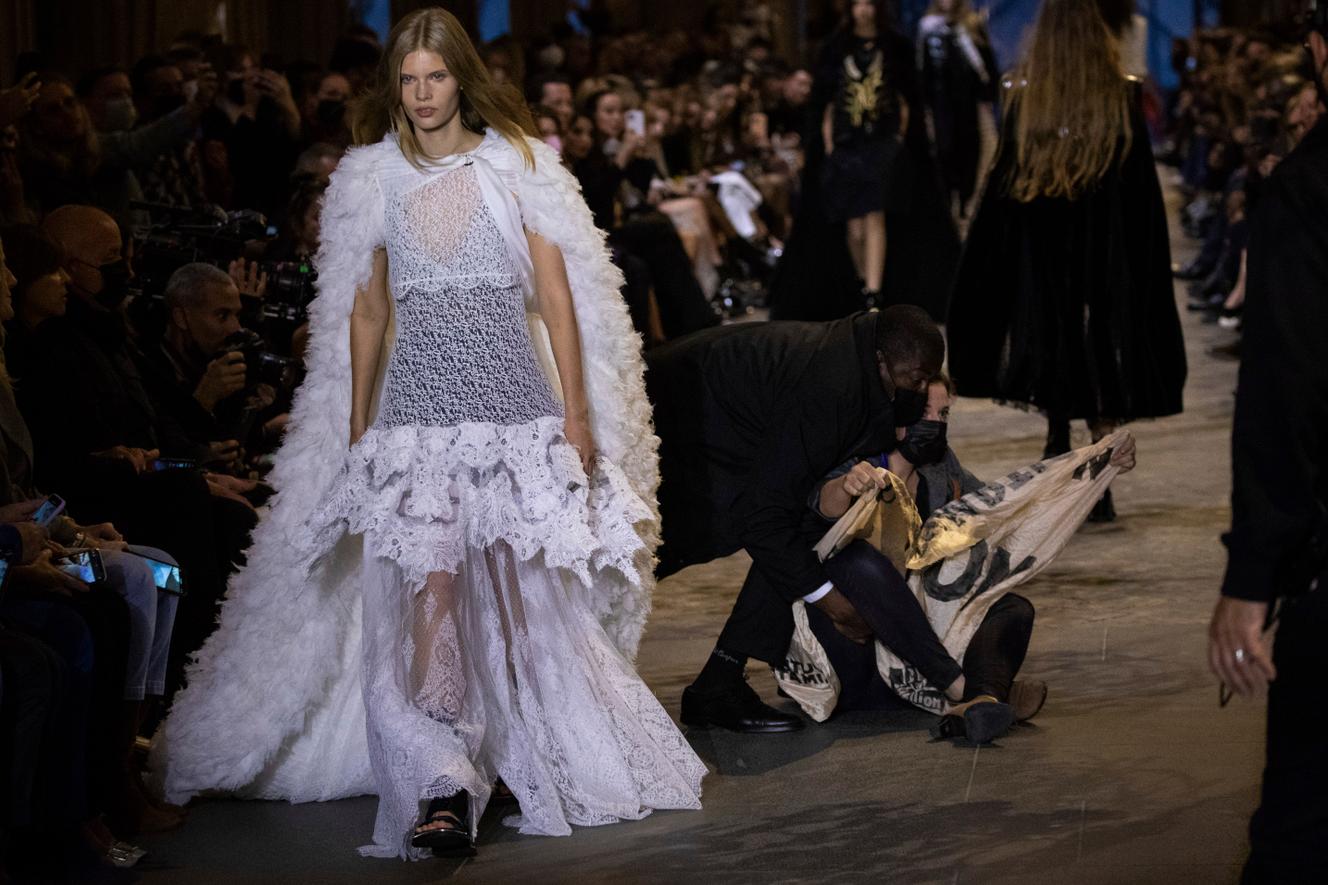 A protester ousted from the runway of the Louis Vuitton spring-summer 2022 ready-to-wear fashion show in Paris, October 5, 2021.