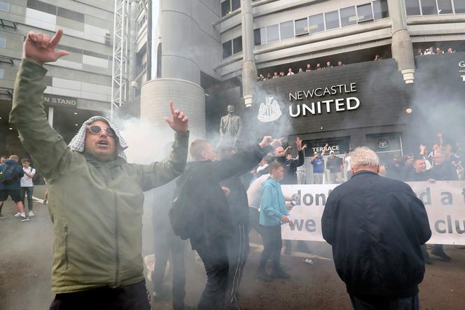 Newcastle United supporters celebrate the club's purchase announcement outside Newcastle Stadium on October 7, 2021.