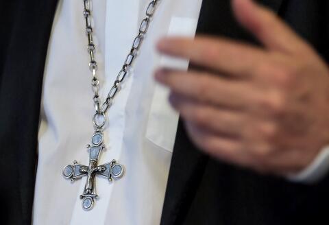 A pisture shows the crucifix arund the neck of Archbishop of Lille Laurent Ulrich during a meeting organised by the diocese of Lille around the theme ""The Church confronted with sexual abuse" in Lomme, northern France, on May 2, 2019. (Photo by PHILIPPE HUGUEN / AFP)