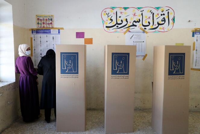 Iraqi women vote at a polling station in Baghdad on October 10, 2021, during parliamentary elections.