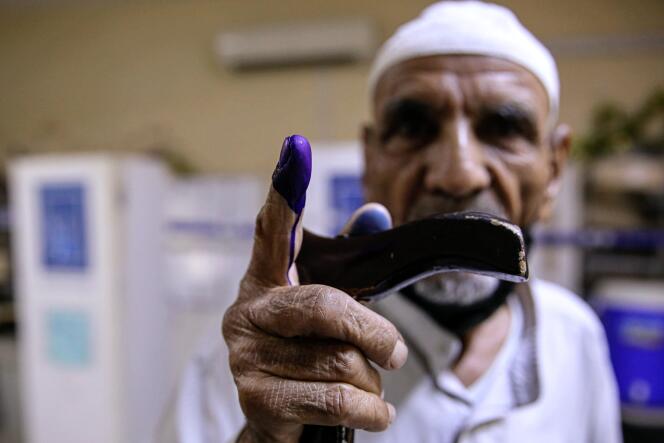 A man shows his ink-stained finger after voting in the parliamentary elections in Basra, Iraq on October 10, 2021.