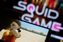 FILE PHOTO: FILE PHOTO: The Netflix series "Squid Game" is played on a mobile phone in this picture illustration taken September 30, 2021. REUTERS/Kim Hong-Ji/Illustration/File Photo/File Photo