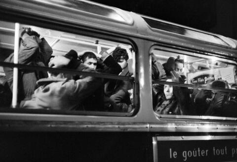 (FILES) In this file photograph taken on October 17, 1961, Algerian demonstrators arrested during the peaceful demonstration, wait with their hands above their heads in a bus requisitioned by the police in Paris. - Sixty years ago, on October 17, 1961, 30,000 Algerians who had come to demonstrate peacefully in Paris were subjected to violent repression. Official assessment: three dead and sixty wounded, very far from reality according to historians. (Photo by - / AFP)