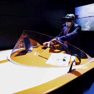 June 30, 2021, Barcelona, Barcelona, Spain: A congress visitor remotely controlling a marine drone on the Orange stand of the Mobile World Congress, during the third day of the event. Thanks to 5G, an unmanned boat located in ValenciaÃ•s port could be controlled, with almost no latency, from Barcelona, about 300km away. Although the control of drones and vehicles remotely is not something new, doing it in a maritime environment presents a difficult challenge due to the interferences of the sea with the radio waves, and has not been seen before. The use of a virtual reality headset and a sailing simulator set makes the experience more immersive to the visitor, who could freely move the drone inside a secured delimited area in the seaport of SpainÃ•s third biggest city. (Credit Image: © Brisa Palomar/Pacific Press via ZUMA Wire)