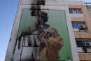 A damaged poster of ousted Libyan leader Muammar Gaddafi is seen in Tripoli September 7, 2011. Picture taken September 7, 2011. REUTERS/Anis Mili (LIBYA - Tags: POLITICS CONFLICT) )