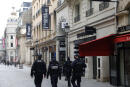 Policemen patrol near Le Printemps shopping center in Paris on January 31, 2021, as big shopping centres are closed as a measure taken to curb the spread of the Covid-19. - France closed its borders to all non-EU travellers except those on essential trips, and closed big shopping centres of 20.000m2 or more, except those selling food. (Photo by GEOFFROY VAN DER HASSELT / AFP)