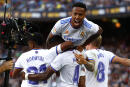 Real Madrid's David Alaba, down center, celebrates with teammates after scoring his sides first goal during the Spanish La Liga soccer match between FC Barcelona and Real Madrid at the Camp Nou stadium in Barcelona, Spain, Sunday, Oct. 24, 2021. (AP Photo/Joan Monfort)