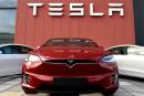 (FILES) In this file photo taken on October 23, 2019 the logo marks the showroom and service center for the US automotive and energy company Tesla in Amsterdam. Tesla shares surged October 25, 2021, briefly lifting the electric car company's market value above $1 trillion, as investors shrugged off criticism from a US safety official of the fast-growing organization. (Photo by JOHN THYS / AFP)