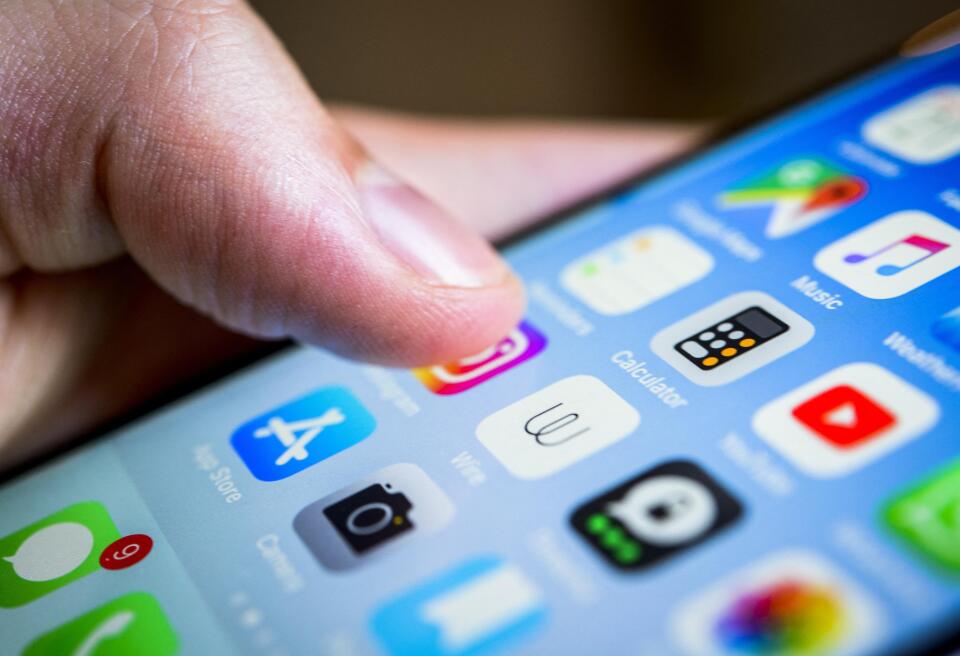 Finger touching display, touchscreen of an iPhone, smartphone, Homescreen, many app icons on the display, Apps, iOS, detail, close-up, Germany, Europe