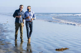 California Gov. Gavin Newsom, left, walks with Wade Crowfoot, California's Natural Resources Secretary, along Bolsa Chica State Beach in Huntington Beach, Calif., site of the recent offshore oil spill, on Tuesday, Oct. 5, 2021. Newsom proclaimed a state of emergency in Orange County to support the emergency response to the oil spill that originated in federal waters. (Mark Rightmire/The Orange County Register via AP)