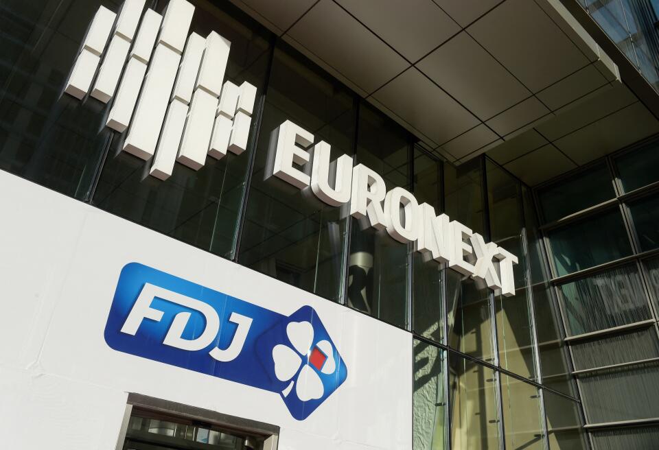 The logo of France's lottery Francaise des Jeux (FDJ) is seen below the Euronext logo after the launch of the initial public offering of FDJ at the Paris Stock Exchange Euronext (Bourse) in Paris on November 21, 2019. - Investors cheered the market debut on November 21 of shares in France's state-owned lottery monopoly, with eager buyers pushing the stock up more than 15 percent in the opening minutes of trading. (Photo by Eric PIERMONT / AFP)