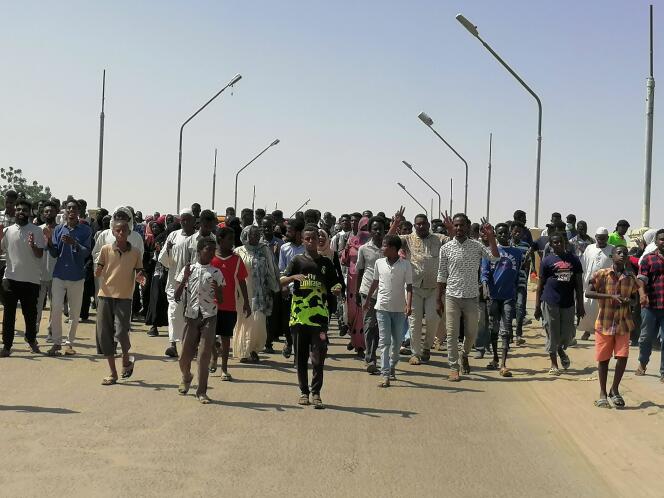 Sudanese protesters march and sing during a protest against the military takeover in Atbara, Sudan, October 27, 2021.