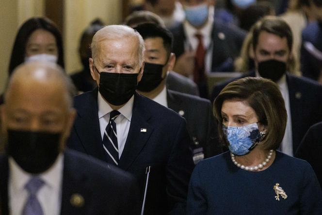 Joe Biden walks into the Capitol building with House Speaker Nancy Pelosi on October 27, 2021, to meet with Democrats at the Built Back Better Project in Washington, DC.