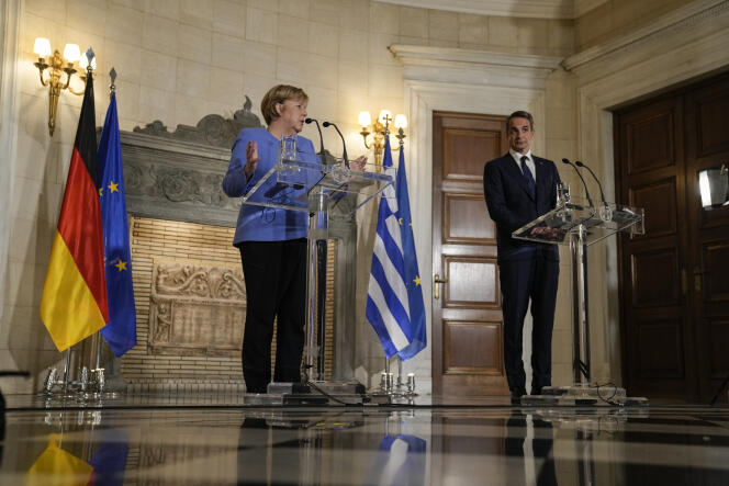 German Chancellor Angela Merkel speaks with Greek Prime Minister Kyriakos Mitsotakis during a press conference at Maximos Mansion in Athens on October 29, 2021.