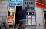 FILE PHOTO: An employee updates fuel price signs at a petrol station in Nice, France, October 13, 2021. REUTERS/Eric Gaillard/File Photo