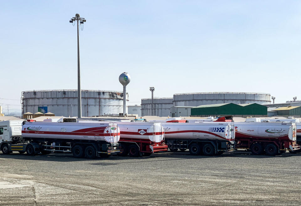 This picture taken November 24, 2020 shows fuel trucks parked near silos at the Saudi Aramco oil facility in Saudi Arabia's Red Sea city of Jeddah. - Yemen's Huthi rebels launched a missile attack on the facility on November 23, triggering an explosion and a fire in a fuel tank, officials said. The strike occurred the day after the kingdom hosted a virtual summit of G20 nations, and more than a year after the targeting of major Aramco sites that caused turmoil on global oil markets. (Photo by Fayez Nureldine / AFP)