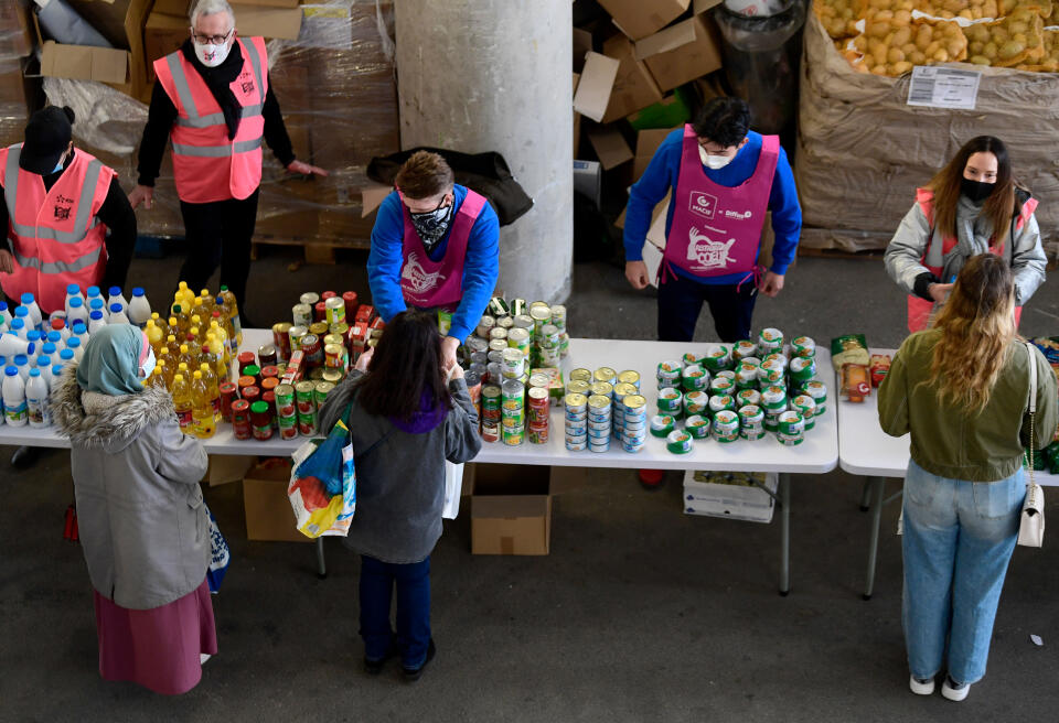 Volunteers of the "Restos du Coeur" charity associaton distribute food and products to students, at the Velodrome stadium in Marseille, southern France, on March 26, 2021, amid the Covid-19 pandemic. (Photo by Nicolas TUCAT / AFP)